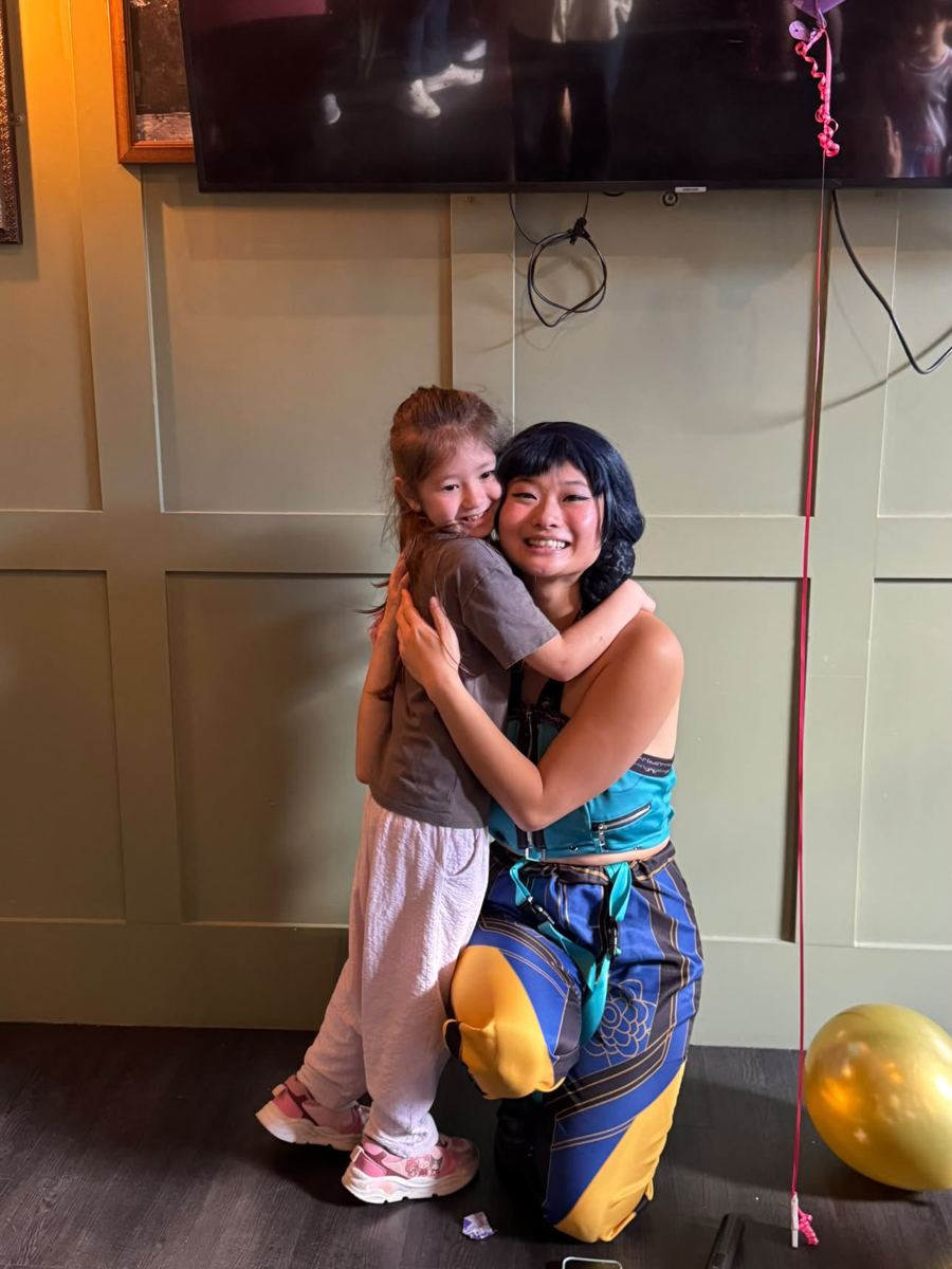 A girl giving the performer a big hug